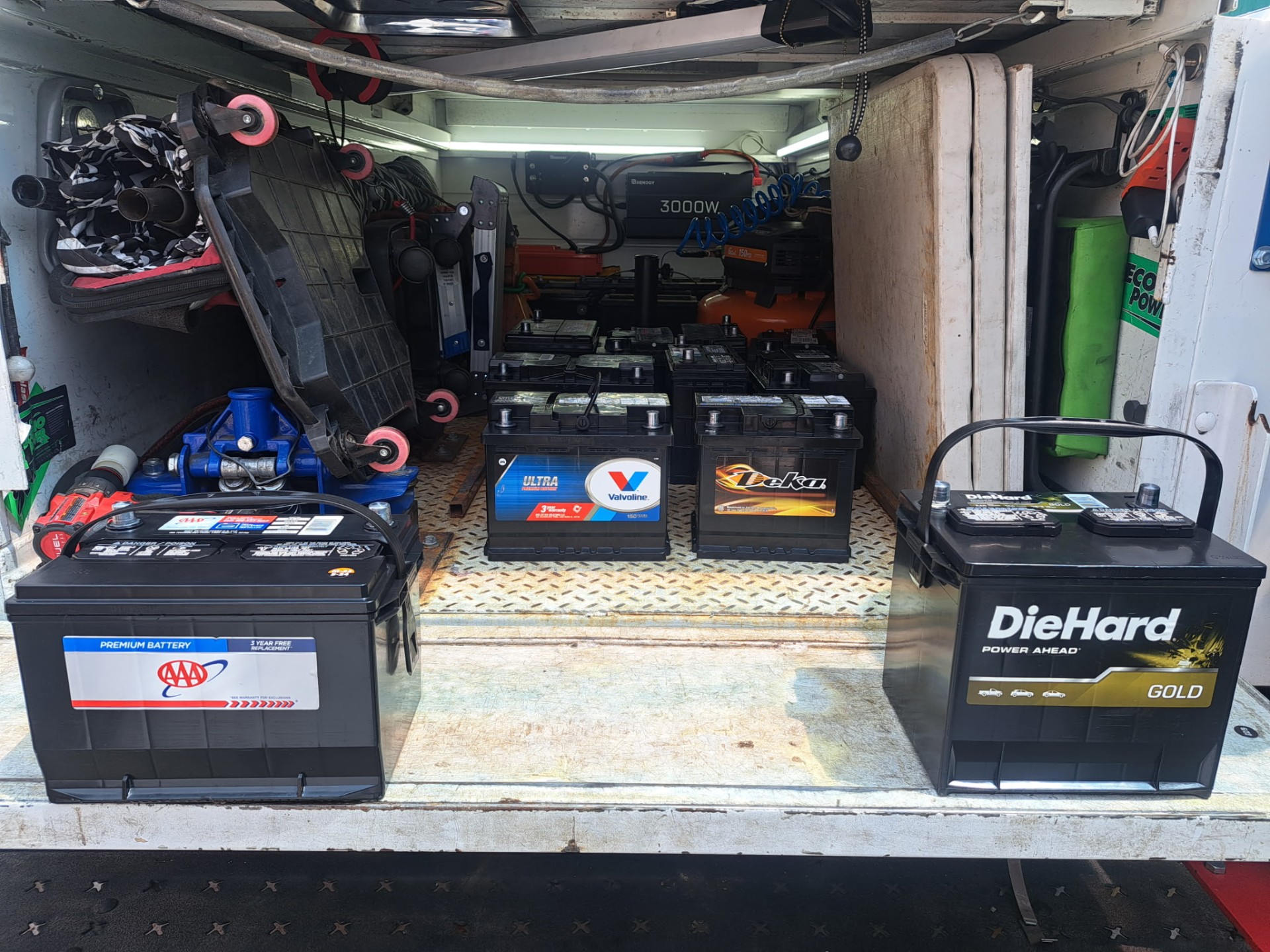 Car and truck batteries stocked in the back of the mobile service truck