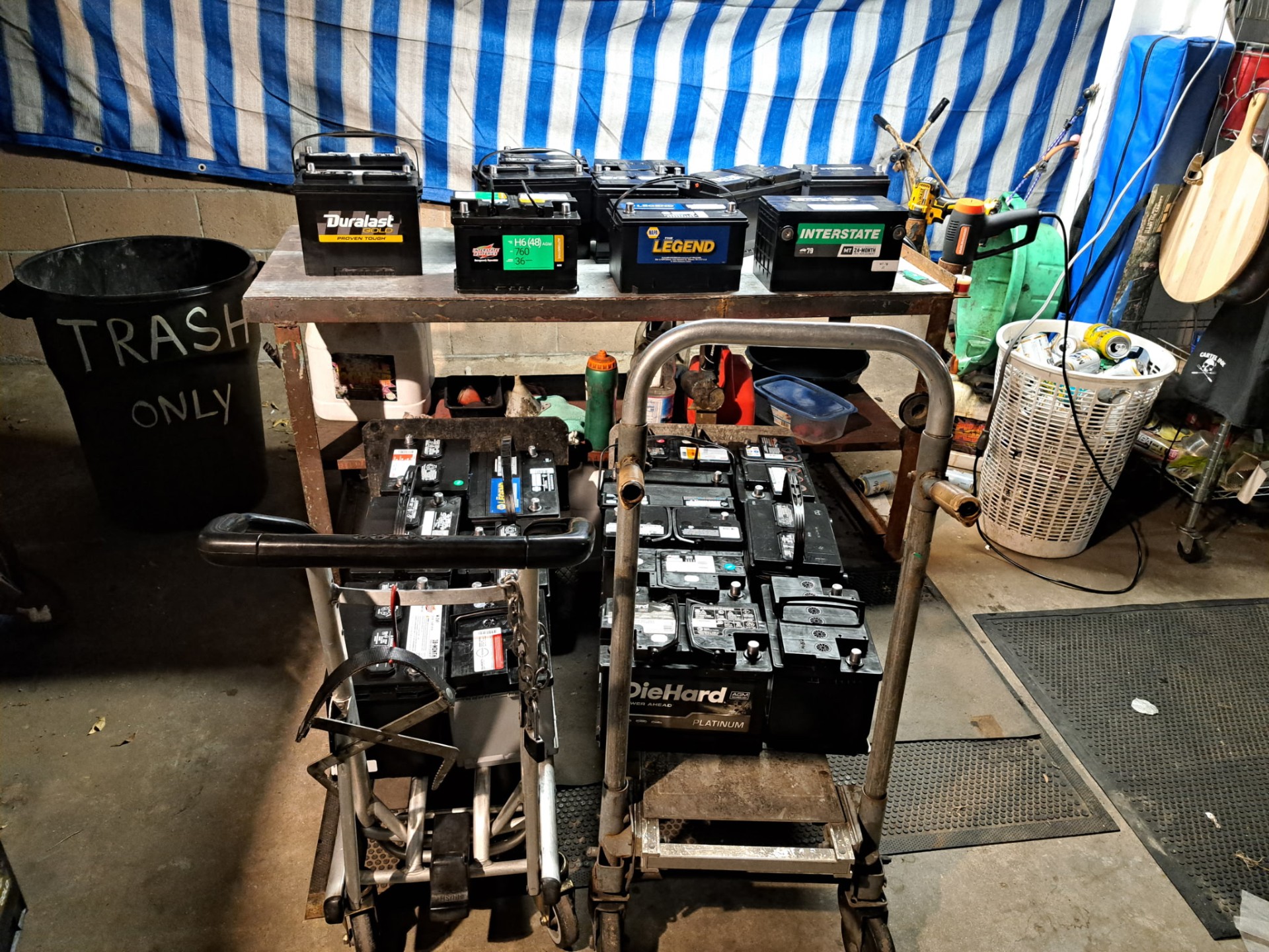 Batteries staged on a workbench and hand carts in the shop